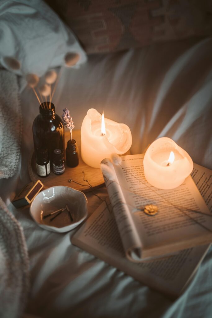 pexels-photo-4099355-4099355 Warm, inviting bedroom setting with candles, books, and soft lighting creating a cozy atmosphere.